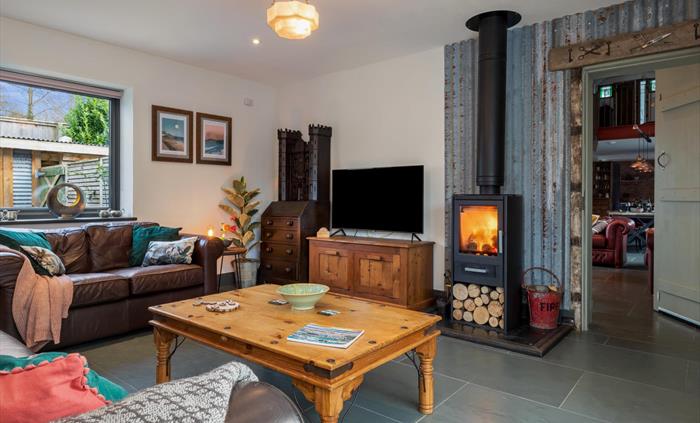 Leather settees in front of wood burning stove. TV with Netflix, WiFi